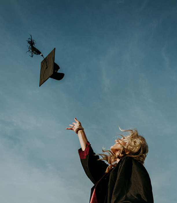 Woman throwing a mortar board cap in the sky