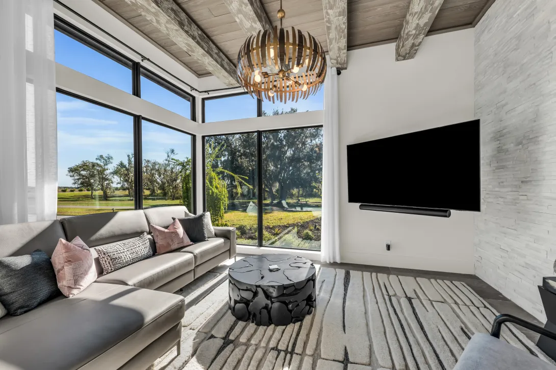 PGT WinGuard Aluminum Picture Window 7720A in bronze with hurricane impact-resistant glass feature in Lee Wetherington’s home.